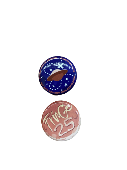 Two Fringe Pins, one on top of the other. One pin is a pink space ship with "Ottawa Fringe Festival" circling the ship on a purple background, and below is a pin that reads "Fringe 25" on a pink moon in a large font.